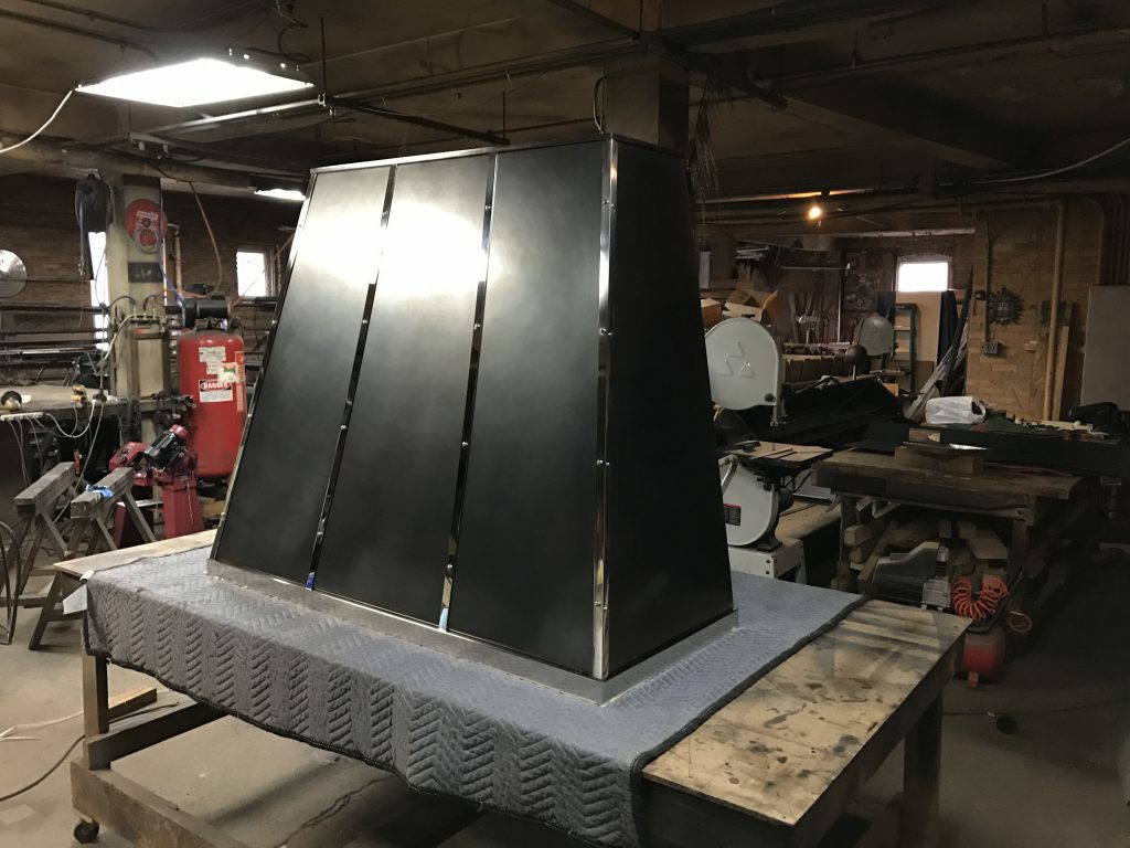 blackened steel stainless steel hood cover with polished nickel details